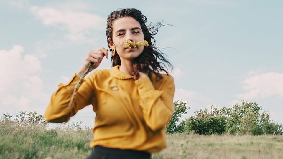 Young woman smelling flower